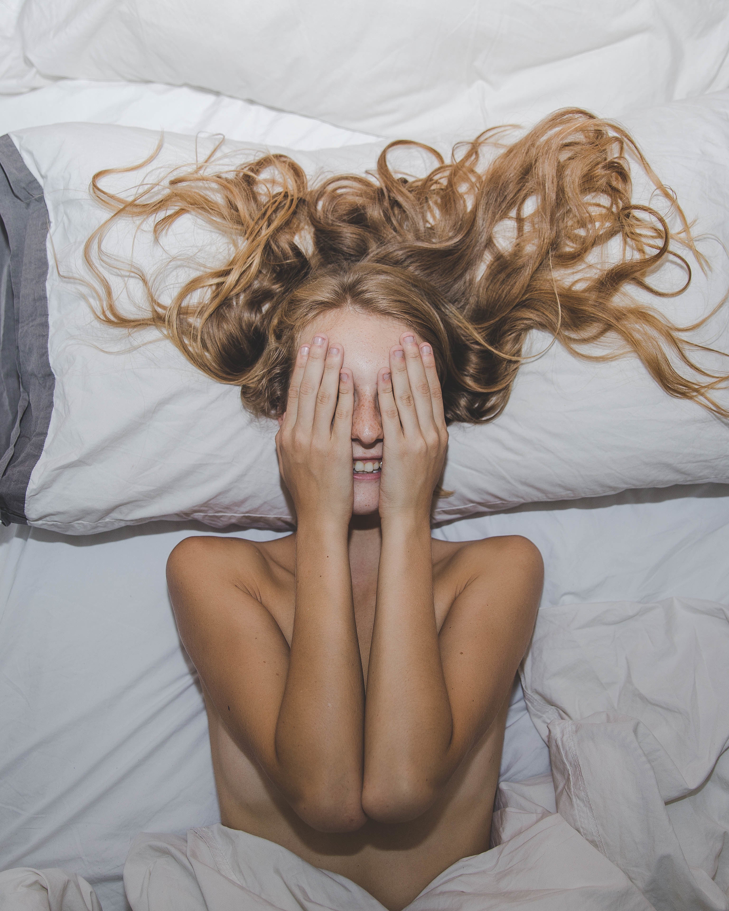 Young woman with blonde hair waking up